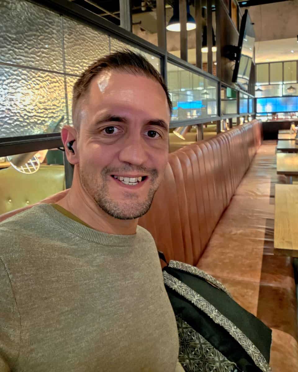 Me in an empty restaurant at Manchester Airport